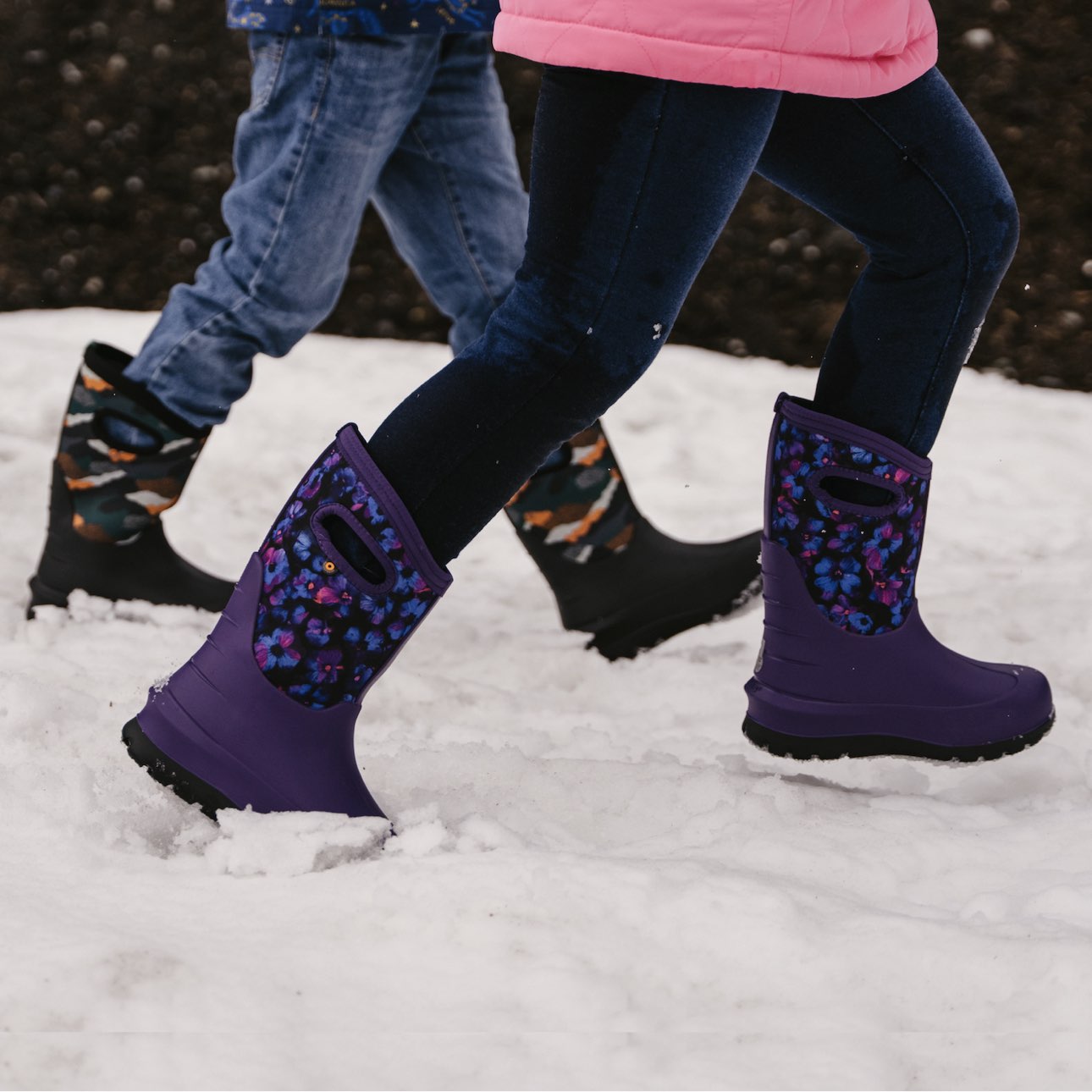 Image features the kid's neo-classic boots walking through the snow.