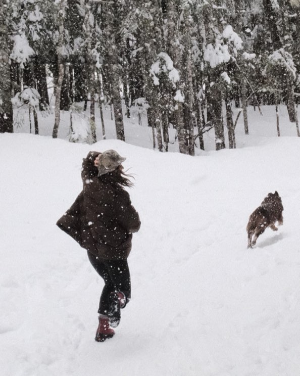 Image features the women's Cedar Quilt in the snow with a dog.