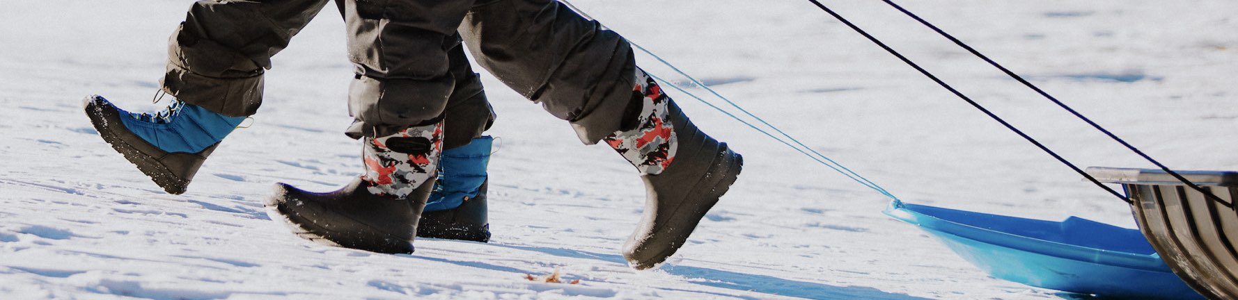 Image features 2 kids insulates styles in the snow. 