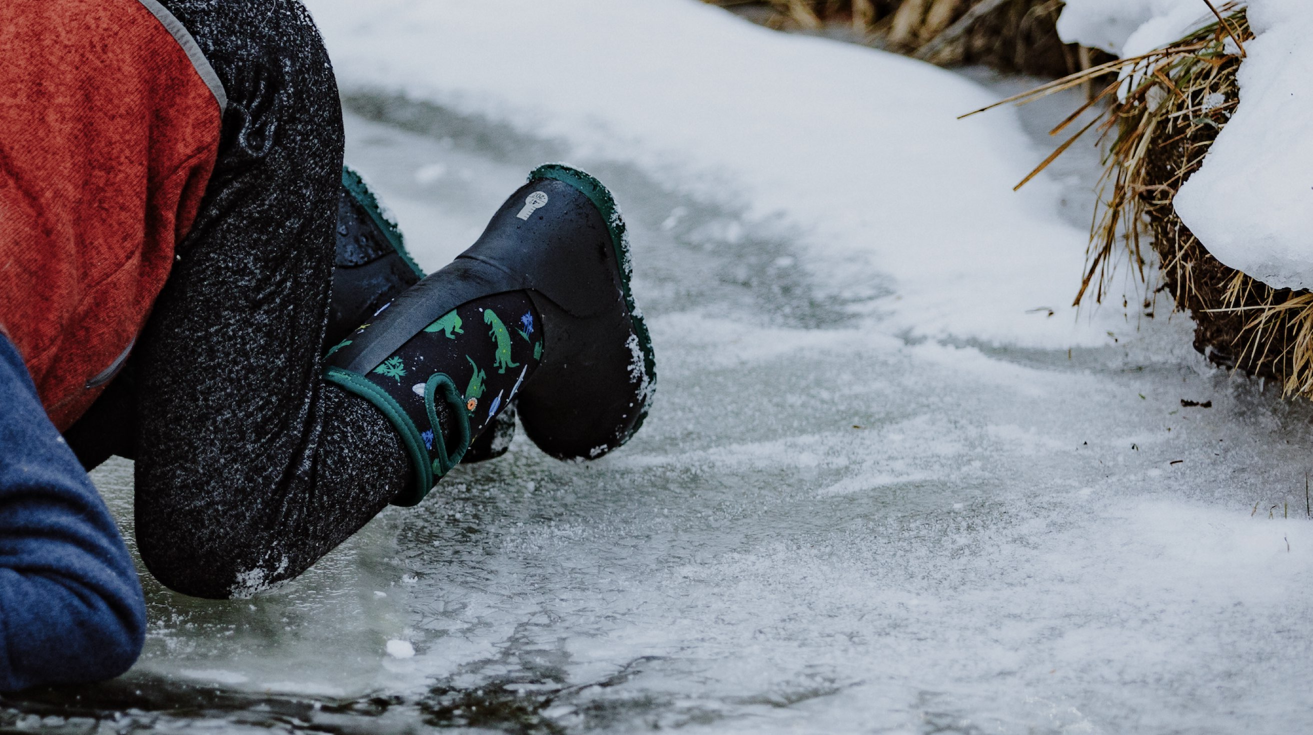 Image features the kids York Jurassic Dino boot on ice. 