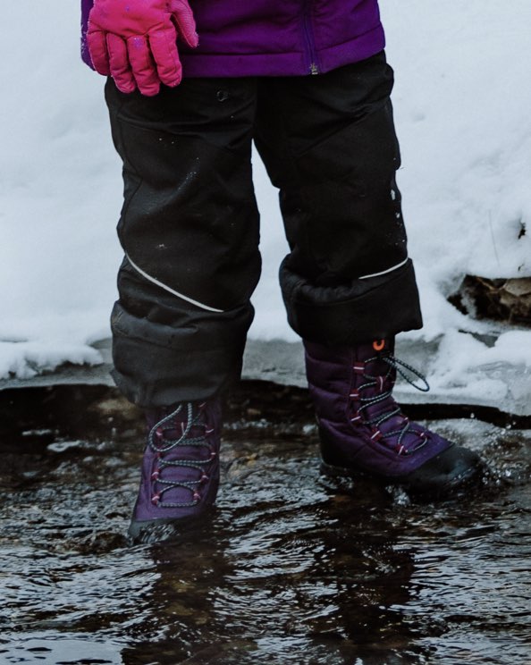 Image features the kids Skyline Snowcata boot in a creek.