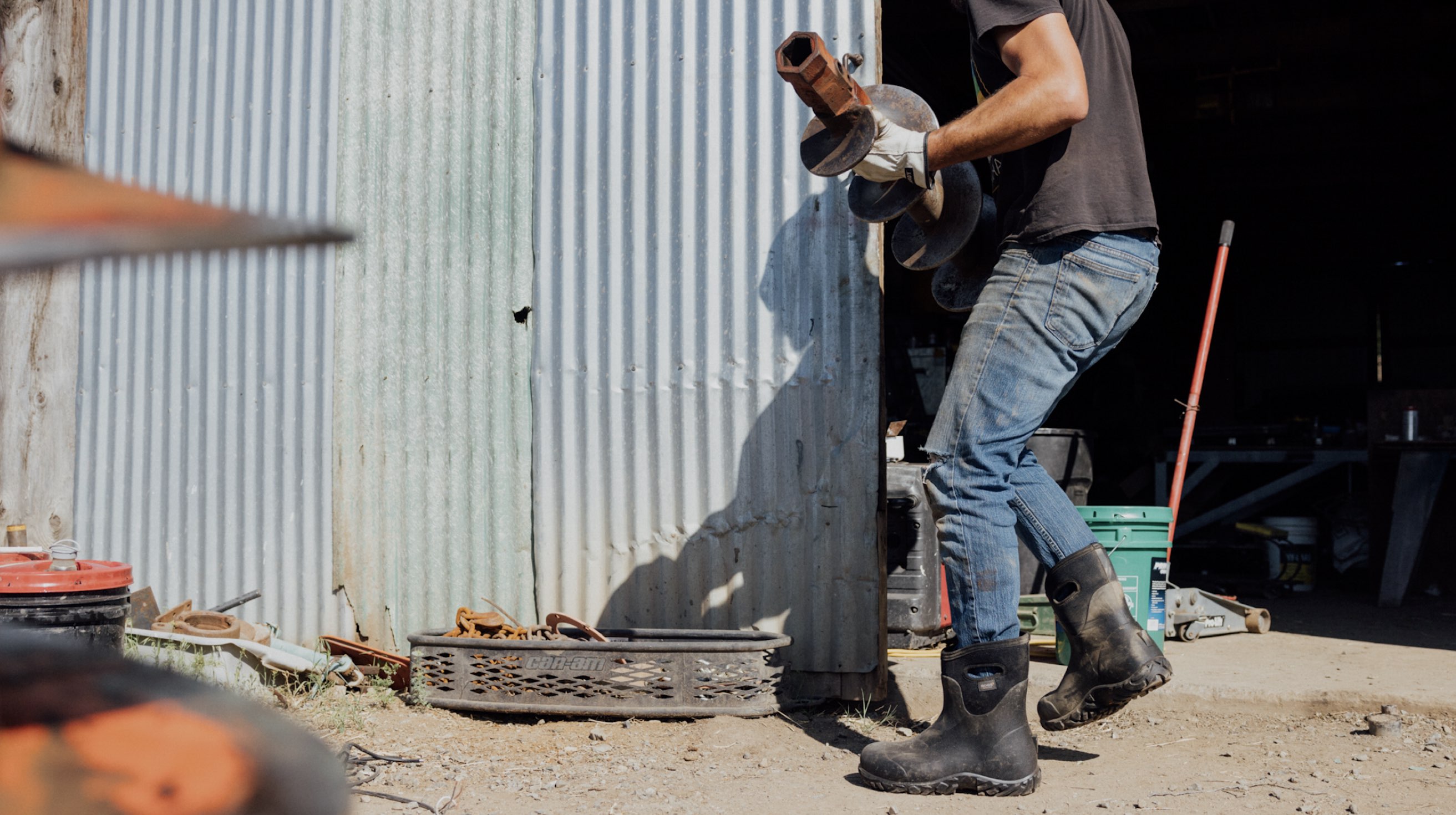 Image features the men's Workman Mid outside a workshop.