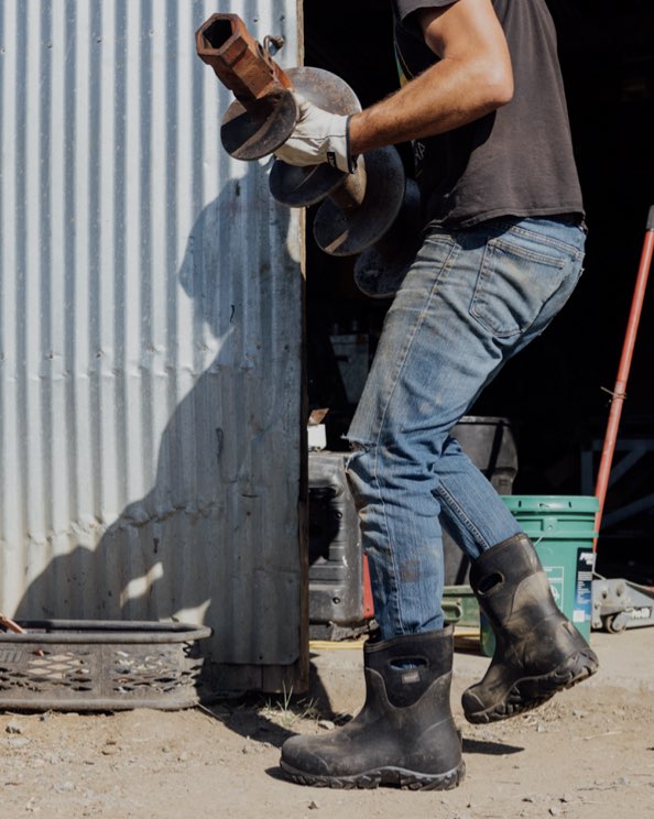 Image features the men's Workman Mid outside a workshop.