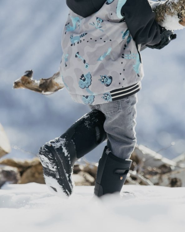 Click to shop Kids' winter boots. Image features the Kids' Classic boot in black in the snow.