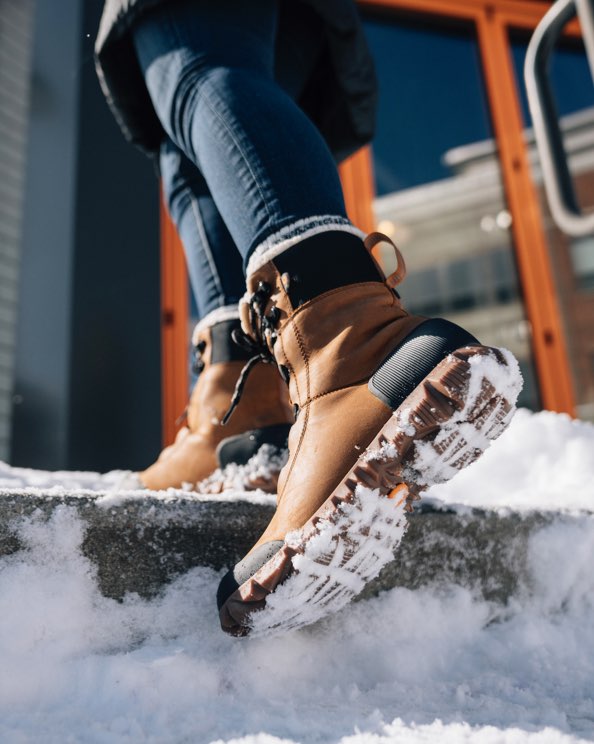 Click to shop Women's Arcata Urban. Image features the style going up snowy stairs.