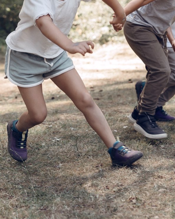 Shop our casual Kids' Skyline Kicker shoes.  The image shown is a waist down shot of a girl running. The boot highlighted our Kids' Skyline Kicker shoes in a variety of colors.