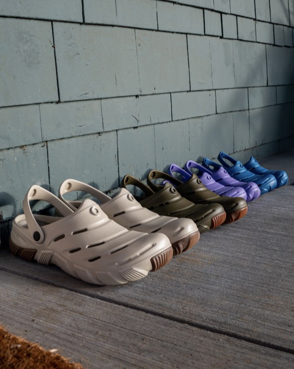 Shop our Men's, Women's & Kids' Boga casual slip on boots. The image shown is our oatmeal and green colorways for Men's & Women's along with purple and blue in Kids'.  These boots are on a house porch.