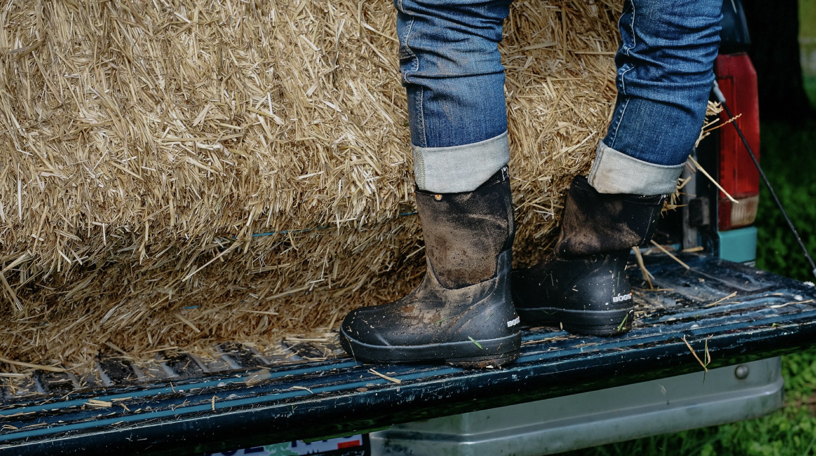 Shop our Women's New Arrivals.  The image shown is a woman leaning back on a brick wall, talking on the phone.  The boot highlighted our Women's Amanda Mid rainboots in yellow.