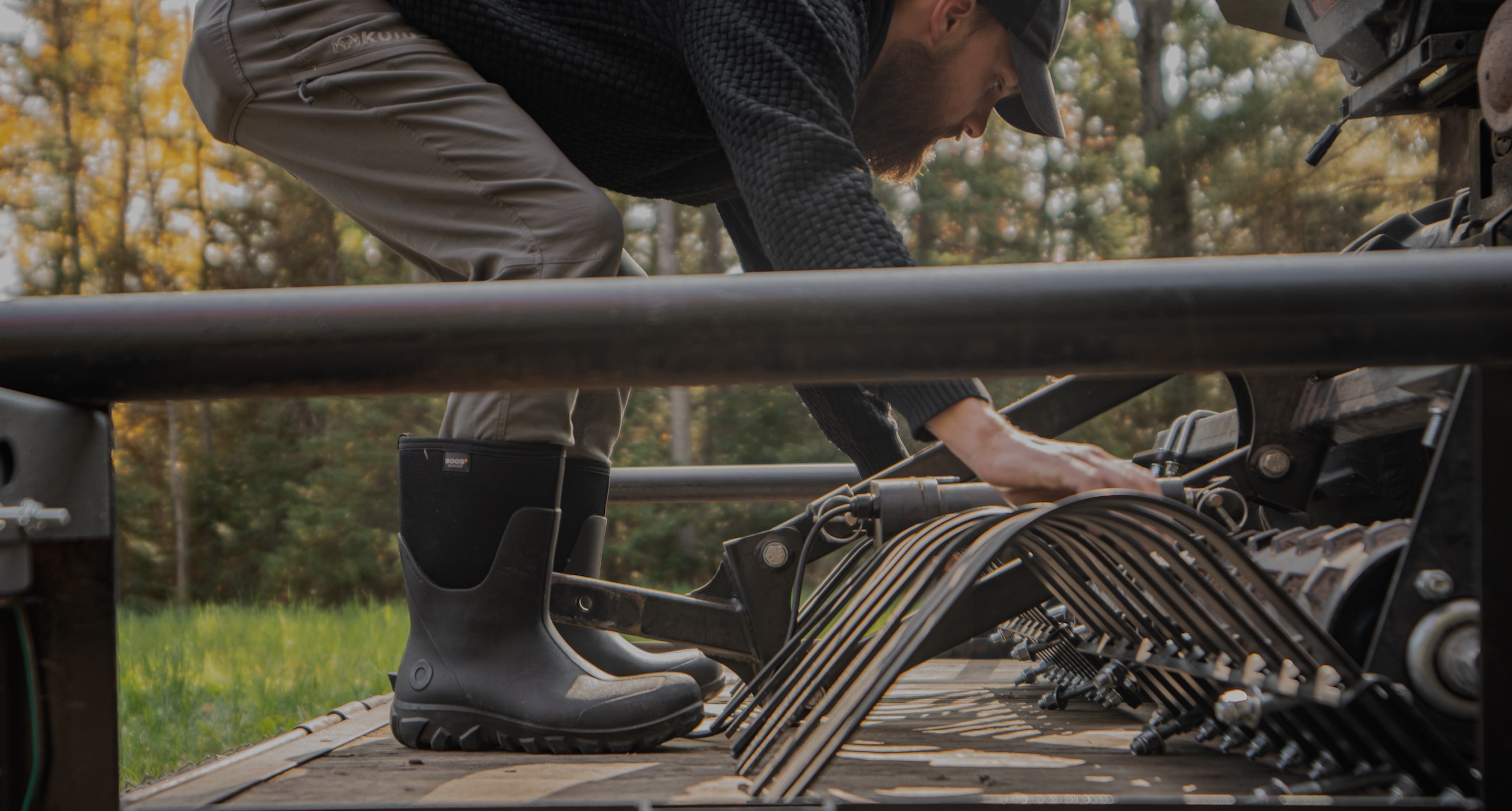 The image shown is a man examining equipment on a truck bed . The boots he is wearing are our Men’s Classic Seamless mid waterproof boots in black. Shop now.