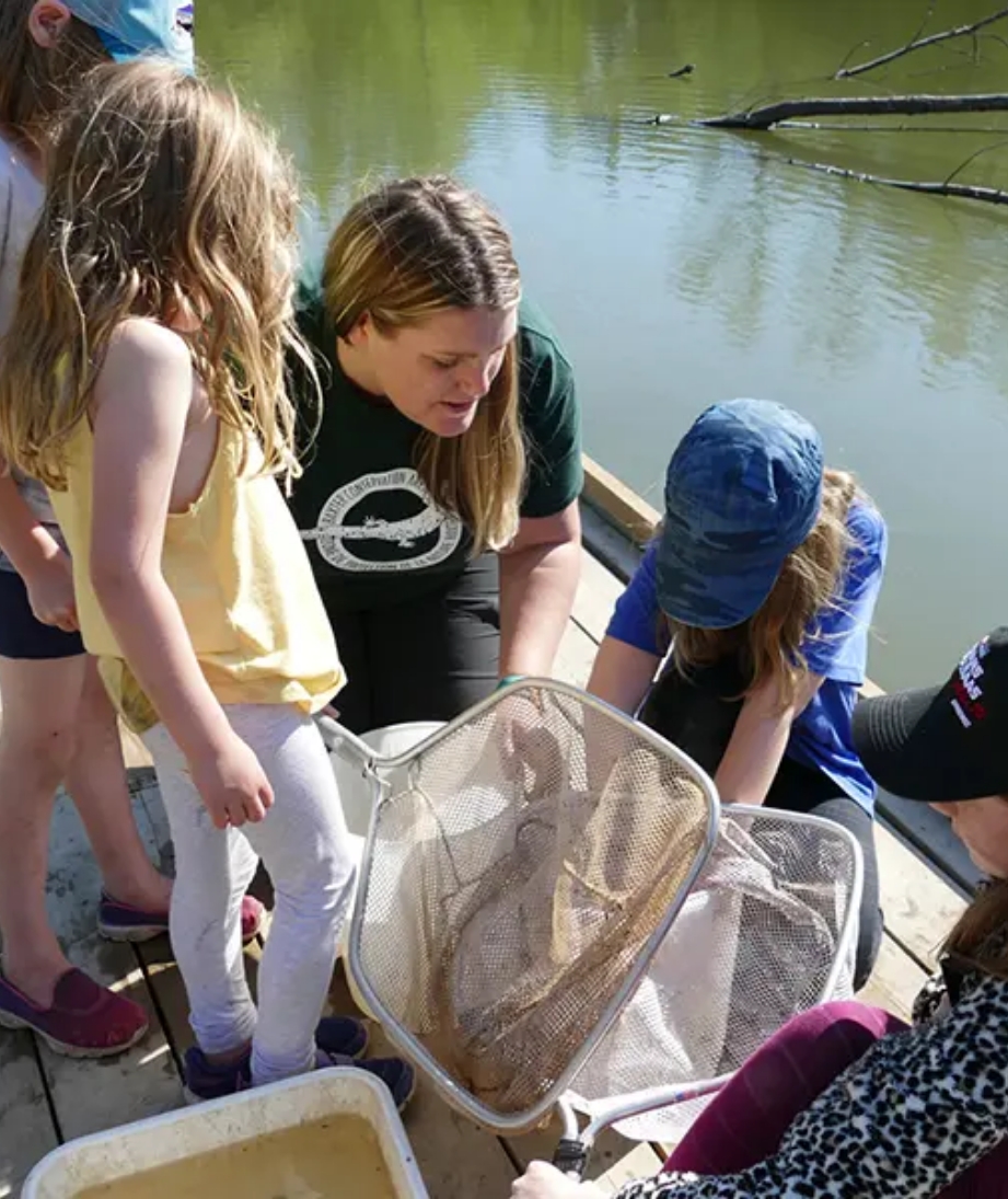 Our Featured Partners. Click here to learn more about the Rideau Valley Conservation Authority organization that provides hands-on watershed restoration and nature experiences for youth. The picture shown is a teacher and four students looking into a net to see what they caught.